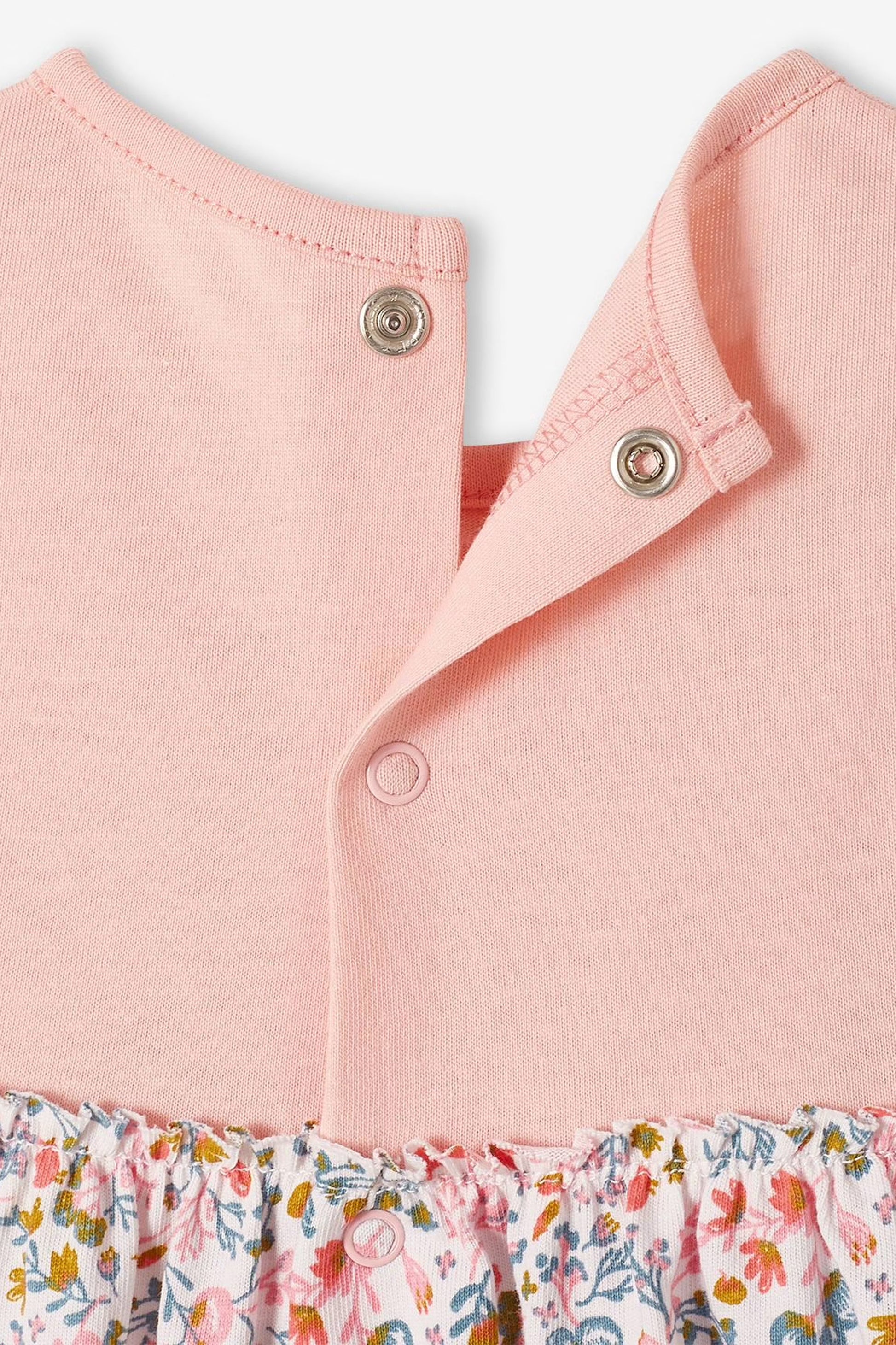 Pink sleeveless dress with floral pattern and matching headband