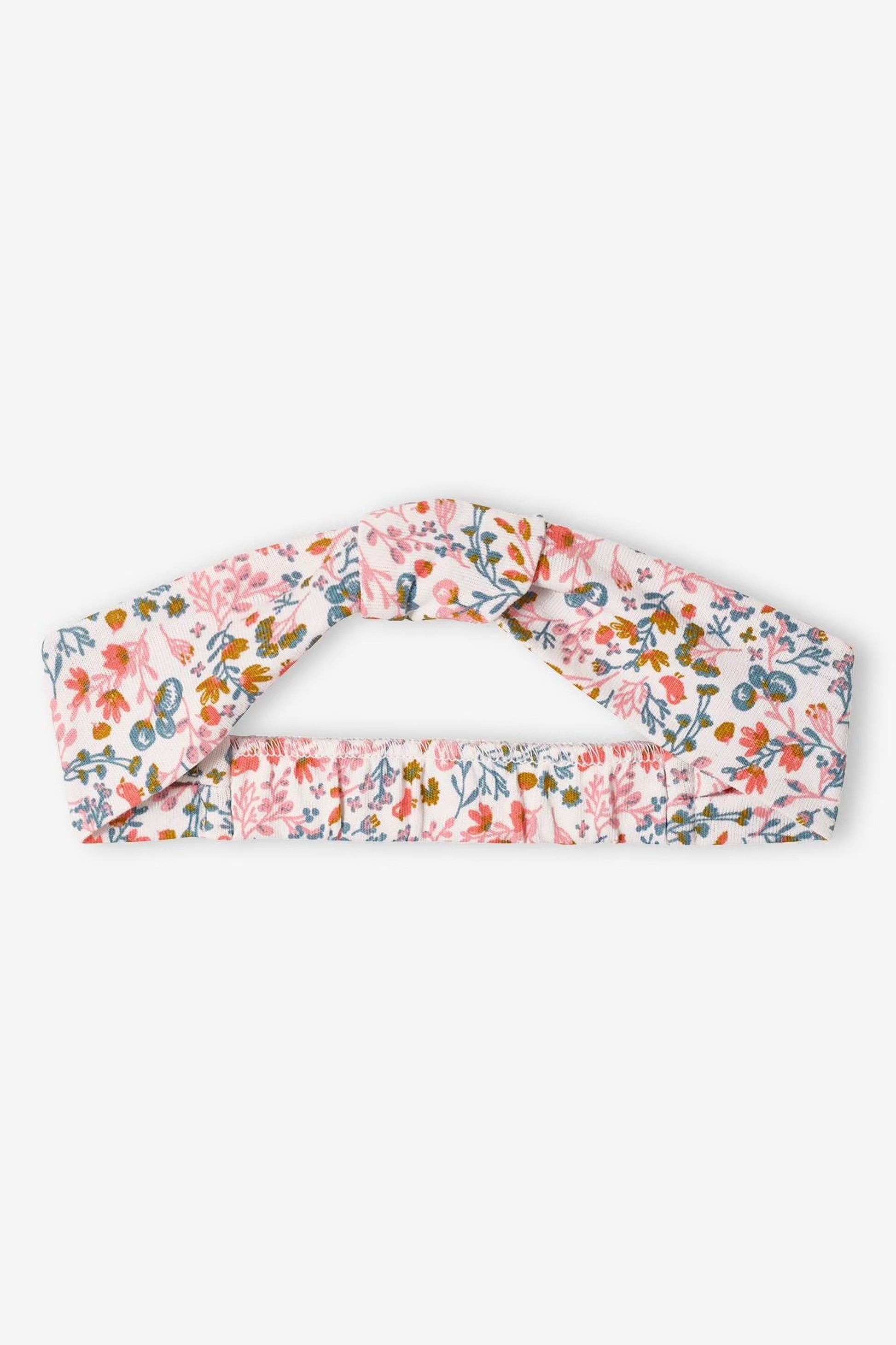 Pink sleeveless dress with floral pattern and matching headband